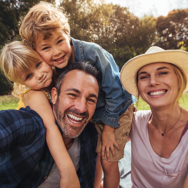 family of four laughing